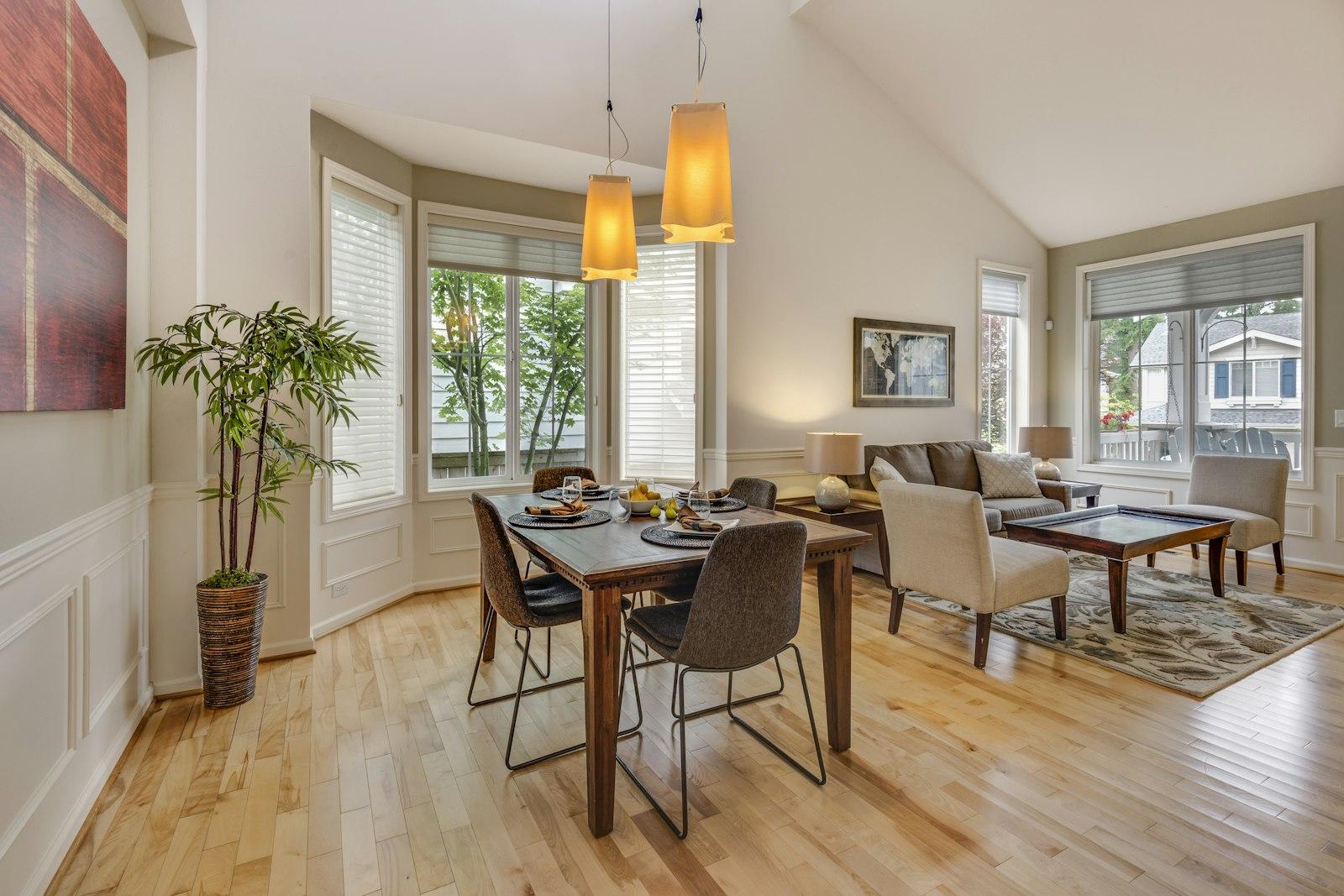 Dining table beside a bay of windows