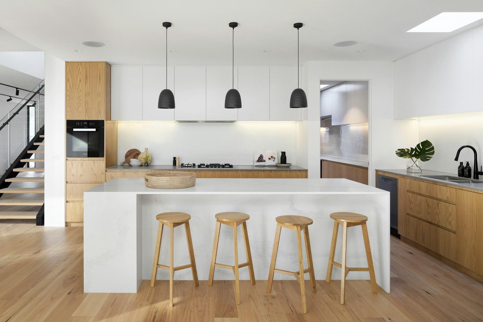 Fitted kitchen with tall cabinet bank and island